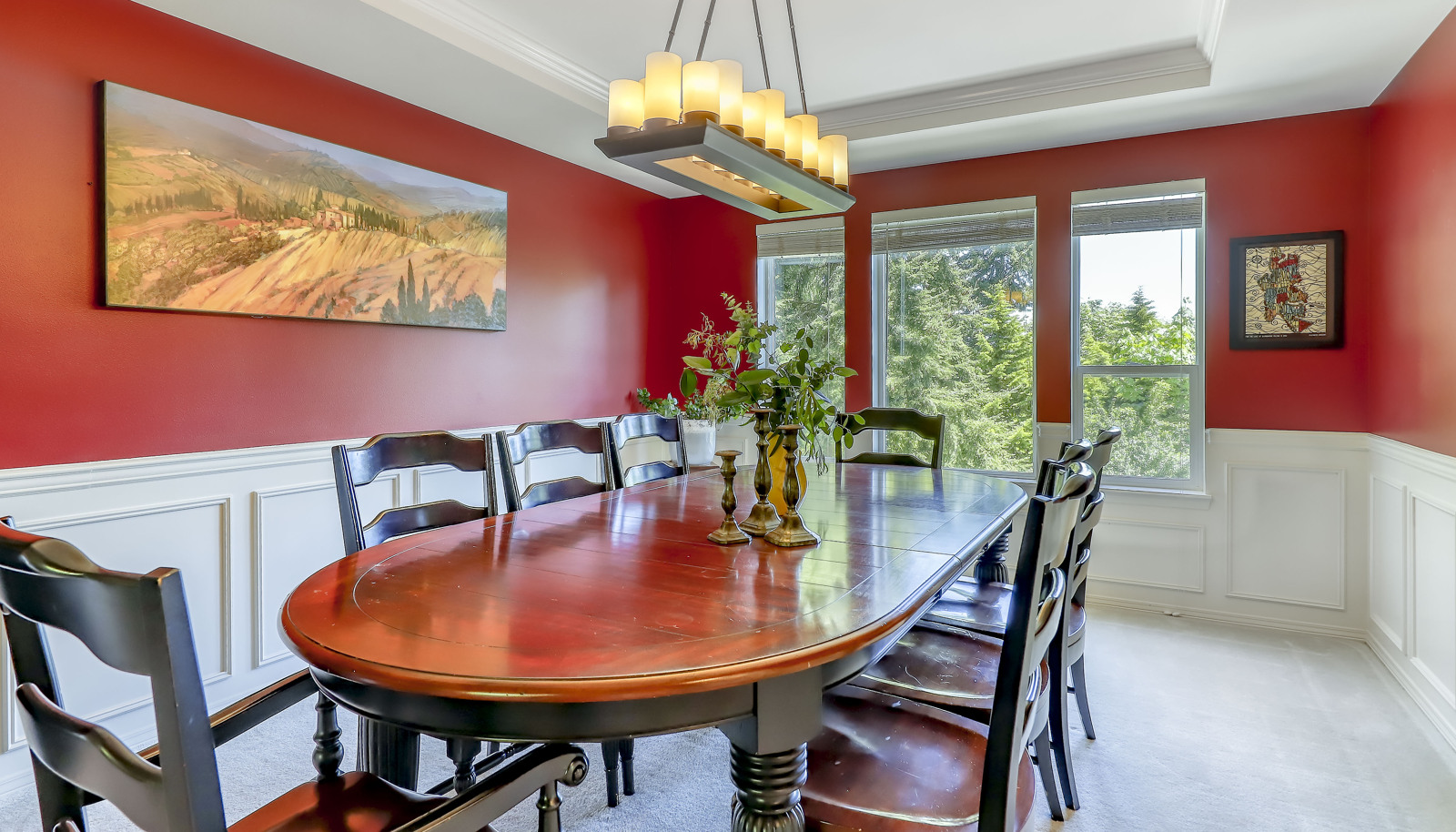 Dining area with wainscot and tray ceiling is very spacious to enjoy many special gatherings.