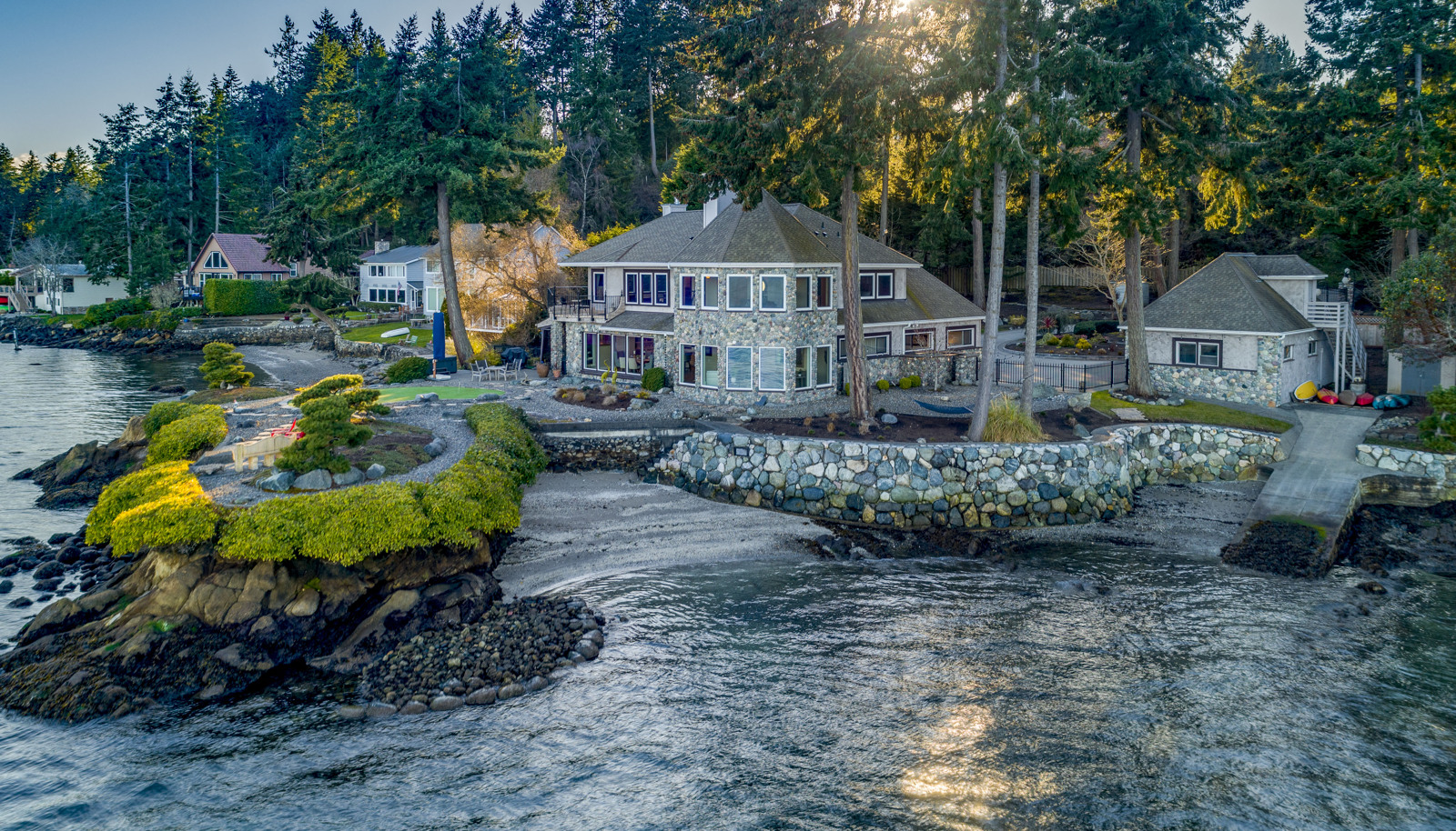 An idyllic waterfront lifestyle and setting with panoramic 240+ degree views, a sandy beach area, and a boat ramp!