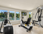 The personal gym with water view, door to the deck and a sauna. 