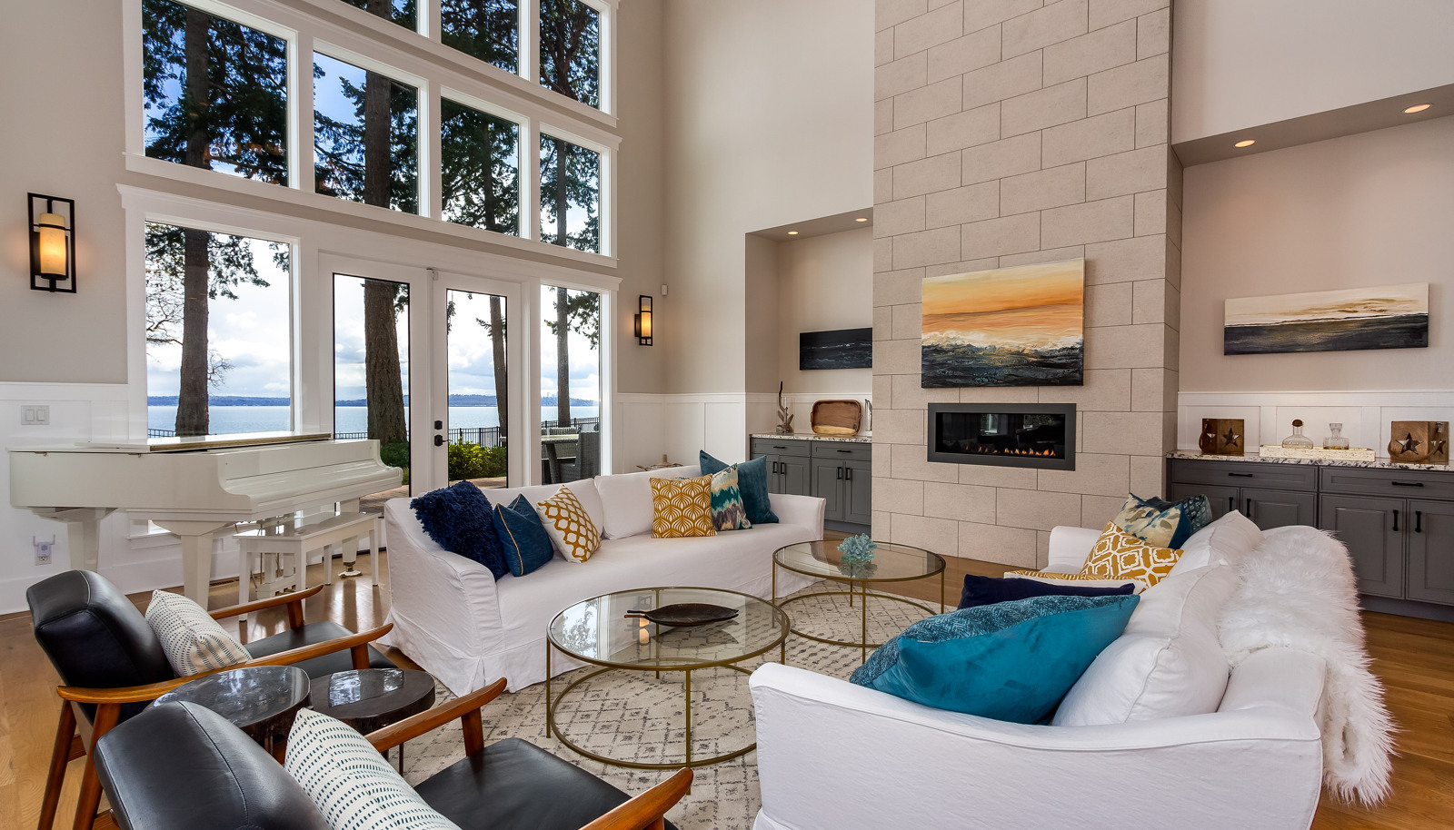 Grand living room, soaring windows and views as far as your eyes can see. Conversations stay cozy by the fireplace. Incredible.