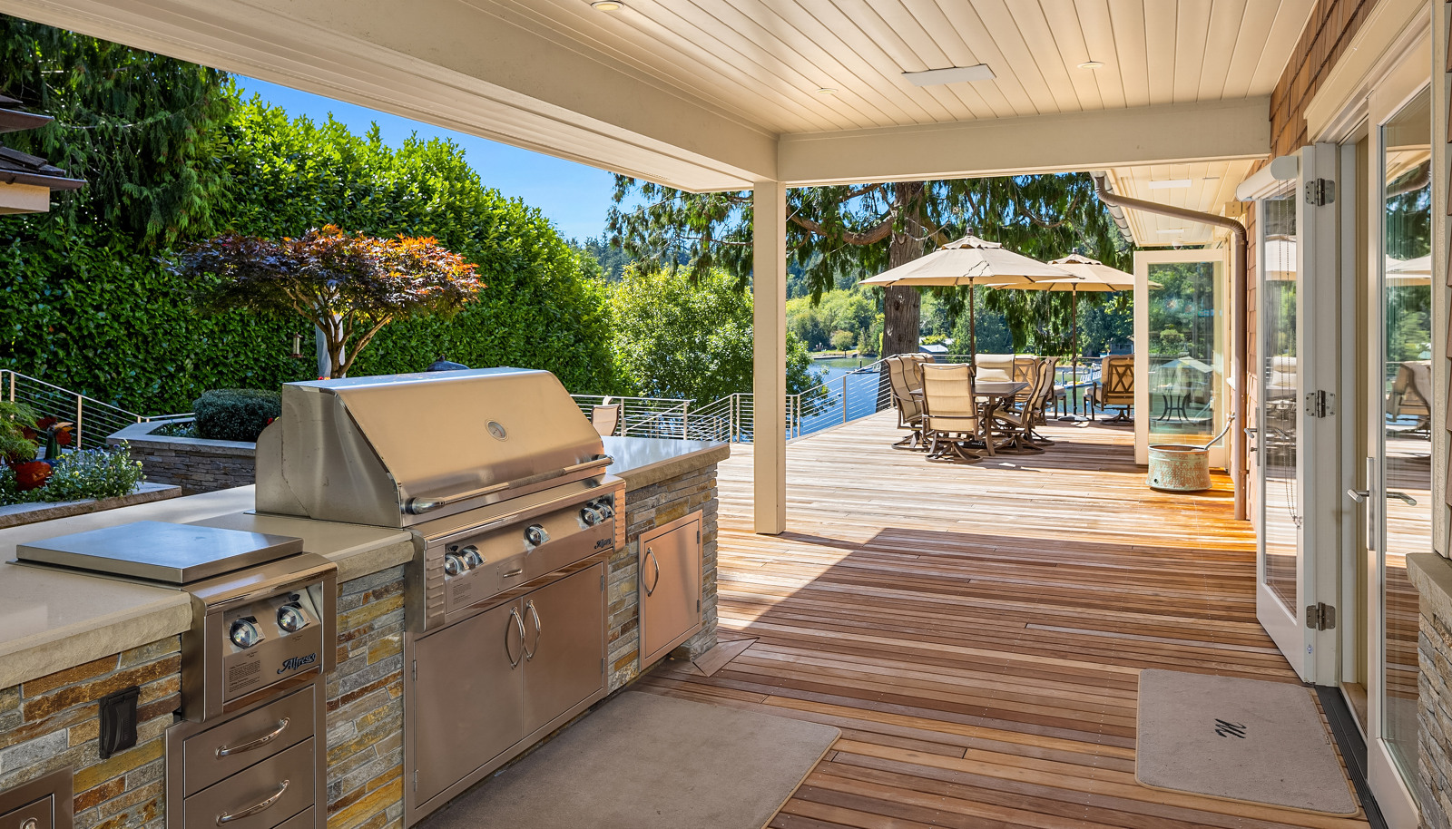 The well appointed, covered (with shiplap ceiling) outdoor kitchen with bbq, warmers and a grill. 