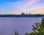 Unobstructed, protected westerly views of the City, Lake, Mountain and sunsets from nearly every square foot of this home.