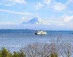 Breathtaking views of Mt. Rainier straight away with deep blue Puget Sound and passing ferries in the foreground.