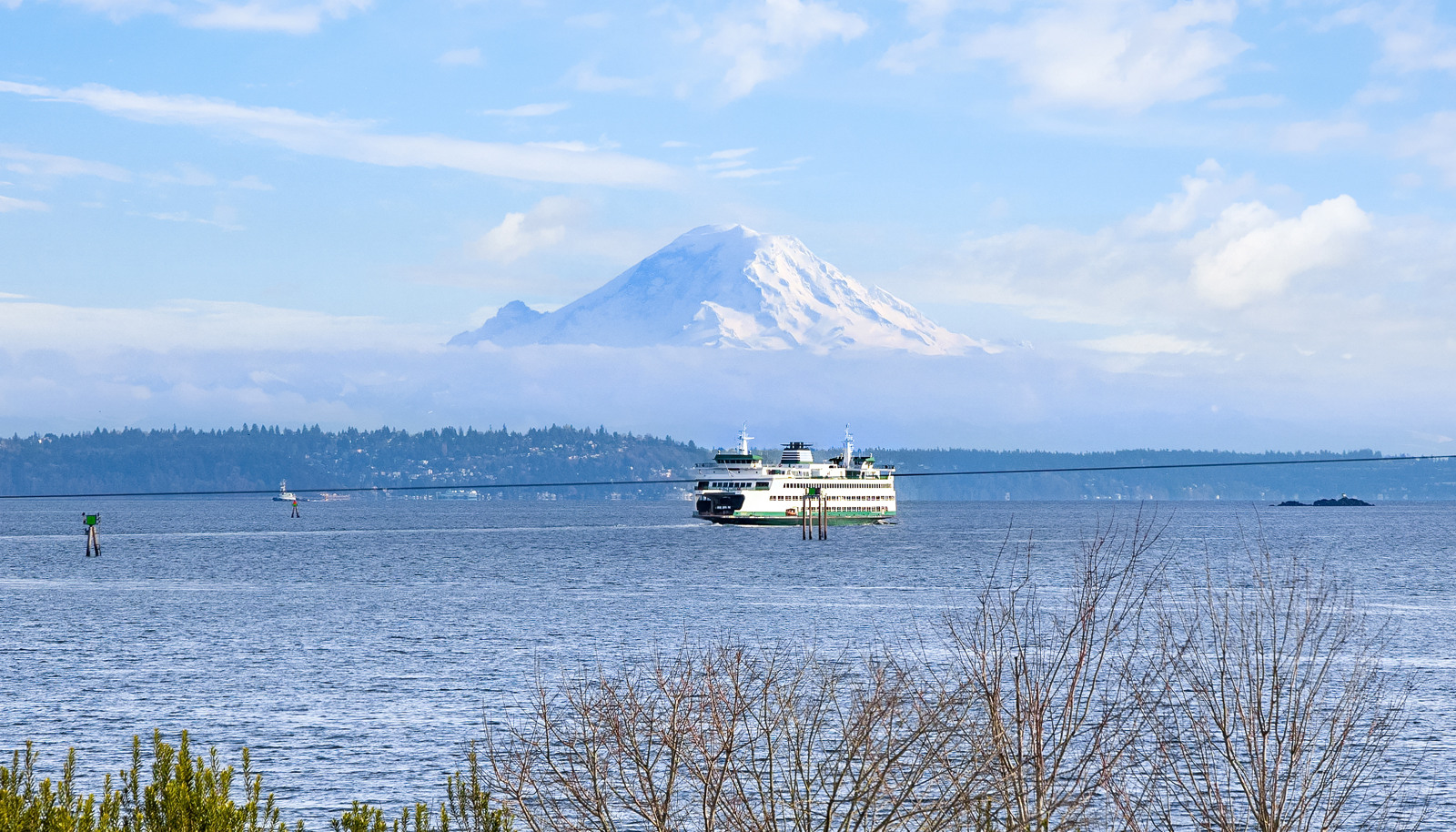 Breathtaking views of Mt. Rainier straight away with deep blue Puget Sound and passing ferries in the foreground.
