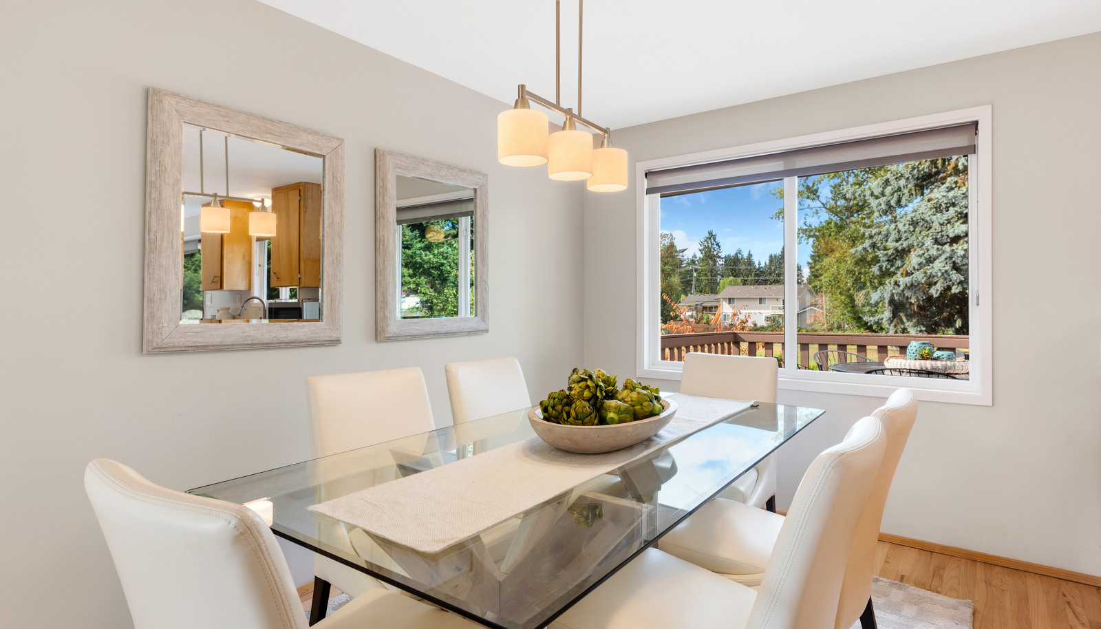 Dining area with window overlooking back yard and park.