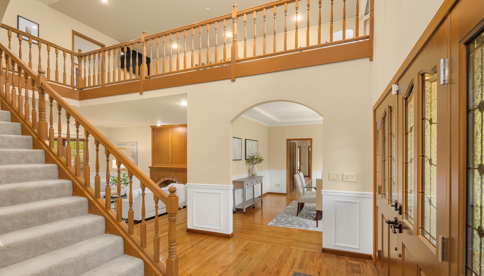 Grand entry with flowing hardwood floors.