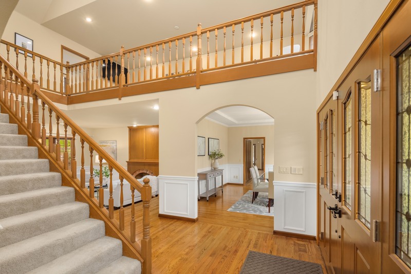 Grand entry with flowing hardwood floors.