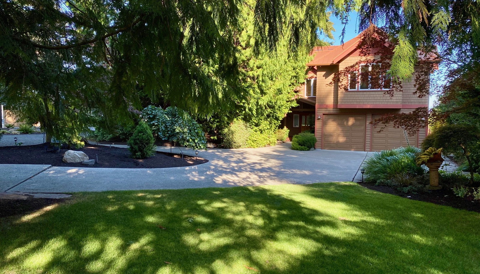 A serene setting with cedar trees, lawns and gardens. Convenience with a paved circular drive. The cottage is just to the left.